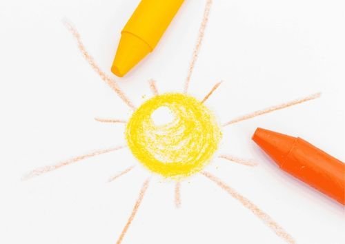 drawing sun with yellow and orange crayon
